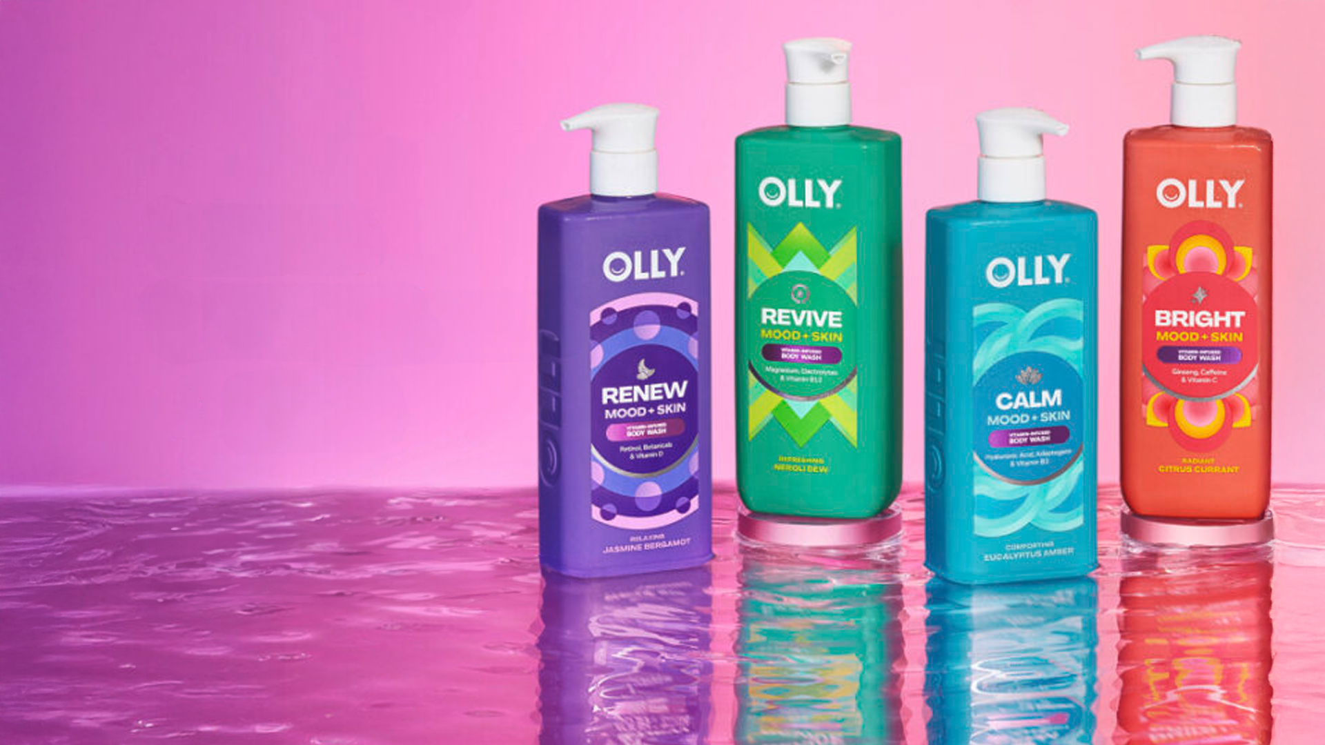Flaconi colorati di bagnoschiuma Olly Mood + Skin su sfondo rosa, progettati per migliorare umore e benessere.